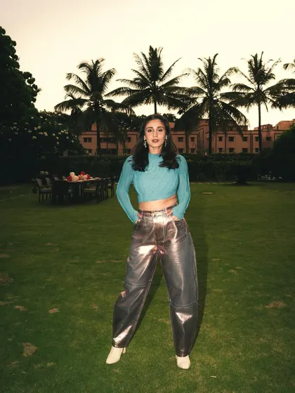 Taking the stage look outdoors. The contrast between the edgy, metallic outfit and the natural garden setting creates a really interesting visual.