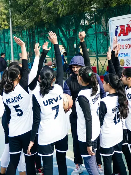 A coach huddles with his team. Teamwork is the beauty of our sport, where five players act as one.