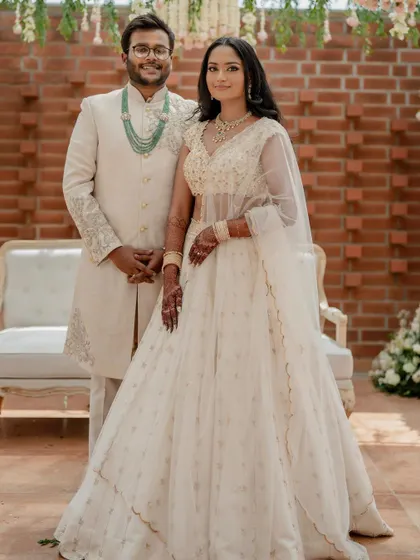 A stunning bride in a white lehenga, exuding grace and elegance. We use creative framing and lighting to capture a variety of beautiful portraits.