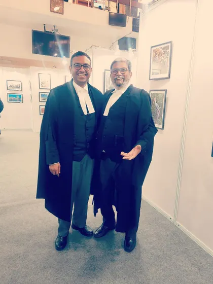 Another photo from the exhibition, sharing a light-hearted moment with a fellow lawyer. These are the moments that build the fabric of our community.