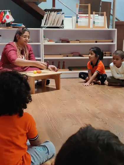 A small group lesson in progress. I present new materials or concepts to a few children at a time, which allows for personalized attention and ensures each child understands before they work independently.