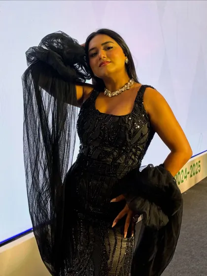 A dramatic pose in my black evening gown. I believe in being "the moment" to create a captivating experience for the audience.
