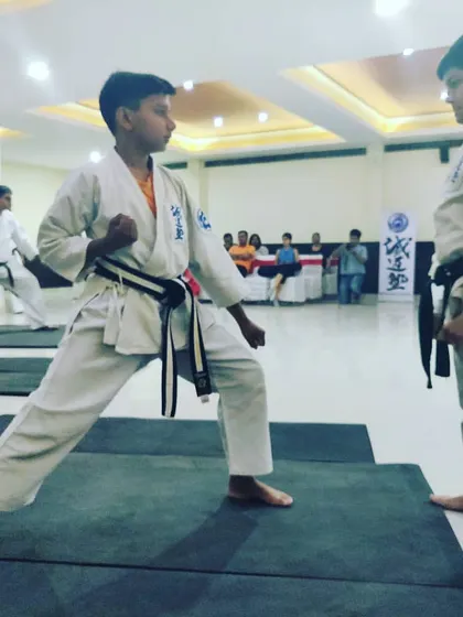 The same student transitions into a ready stance, demonstrating focus and preparation for the self defense drill.