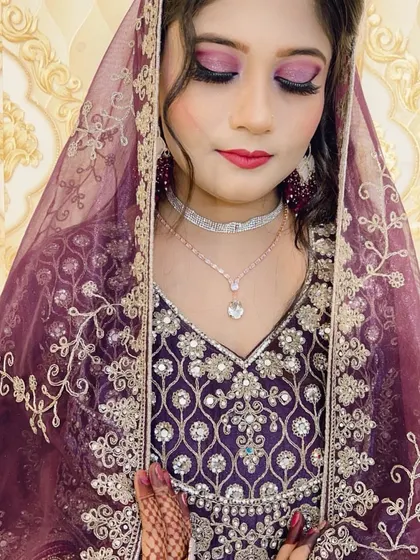 A close-up of the purple reception look, highlighting the glittery purple eyeshadow and flawless skin finish.