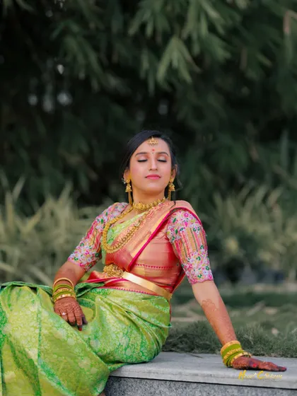 A serene outdoor portrait of the bride, sitting peacefully with her eyes closed, soaking in the moment.
