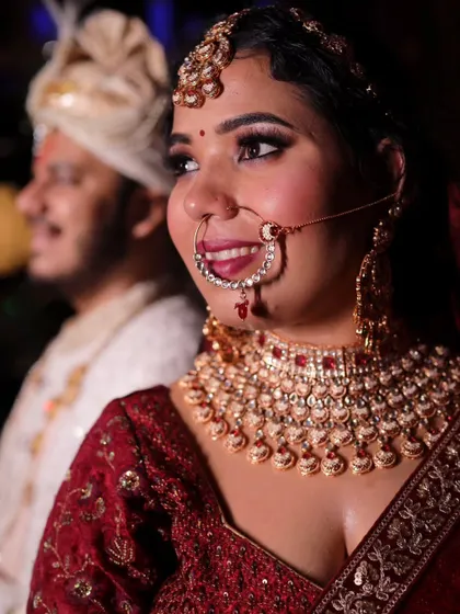 A happy, candid shot of the bride with her groom in the background. Her joyful expression is what makes this photo so special.