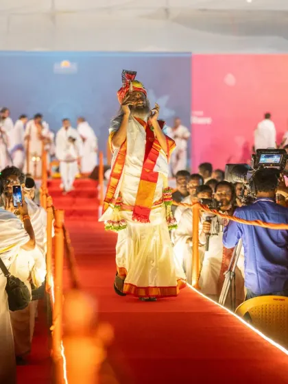 A devotee's view of me arriving for the Maha Shivratri celebration. The excitement and reverence of the crowd are palpable as they capture the moment on their phones.