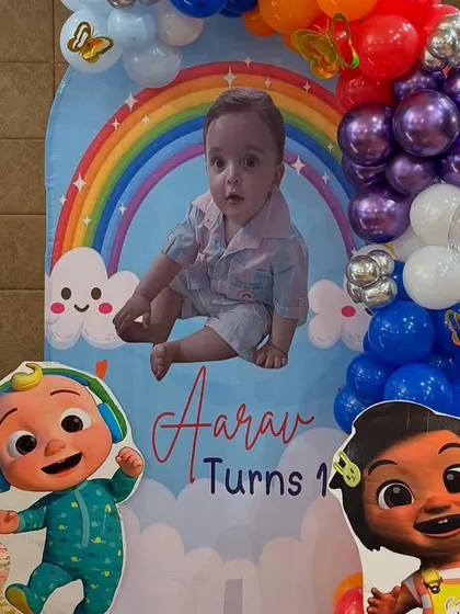 A personalized photo board for Aarav's birthday, featuring a large picture of the birthday boy alongside his favorite Cocomelon characters.