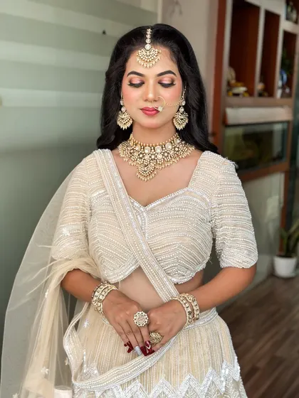 An elegant and sophisticated look in a white lehenga. You'll learn to create soft glam makeup that complements lighter-colored outfits perfectly.