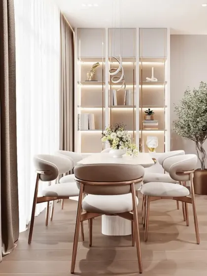 This dining area features a beautiful built-in crockery unit with internal lighting. The elegant chairs and minimalist table create a sophisticated space for family meals.