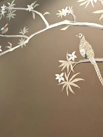 A detail of a pheasant perched on a branch, part of the nature-themed mural designed to create a serene and imaginative environment for a child.