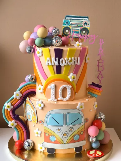 Retro vibes! This two-tiered cake is all about the 70s, with a VW bus, disco balls, and a funky color palette.