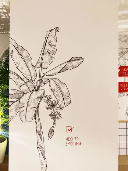 A hand drawn banana tree mural for Smoke House Deli, complete with a playful 'Add to Smoothie' checkbox that engages customers.