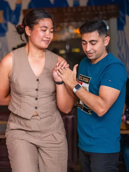 A gentle and focused moment between two dancers.