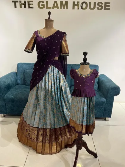 A beautiful mother-daughter twinning moment in custom-made half sarees.