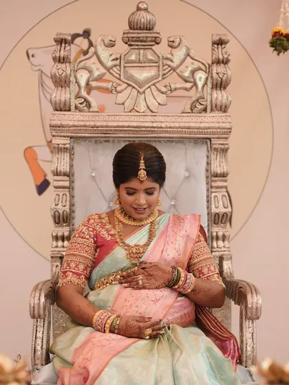 The mother-to-be looking serene and beautiful during her baby shower ceremony, dressed in her custom ethnic wear.
