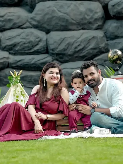 A lovely family picnic setup in our garden. Dressed in coordinating maroon and white, this family's portrait is complete with a mini teepee and vintage props for a stylish outdoor shoot.