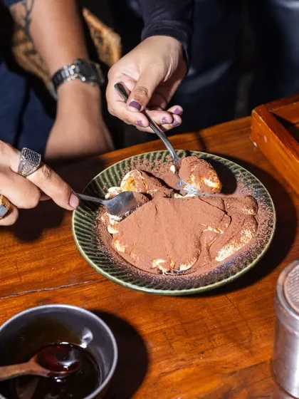 Two spoons dig into a shared bowl of Tiramisu. Desserts are meant for sharing, and this shot captures a moment of connection and indulgence.