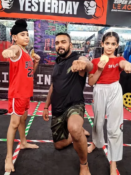 My little fighters. A young boy and girl posing with me, showing their fighting spirit.