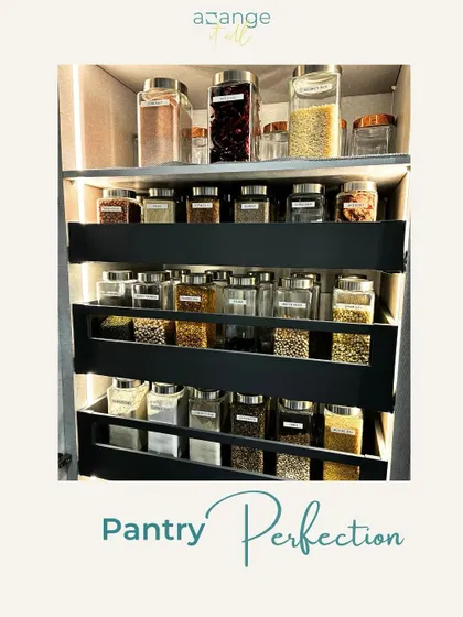 Pantry perfection. A pull-out pantry with slanted shelves, filled with labeled spice jars for ultimate visibility and access.