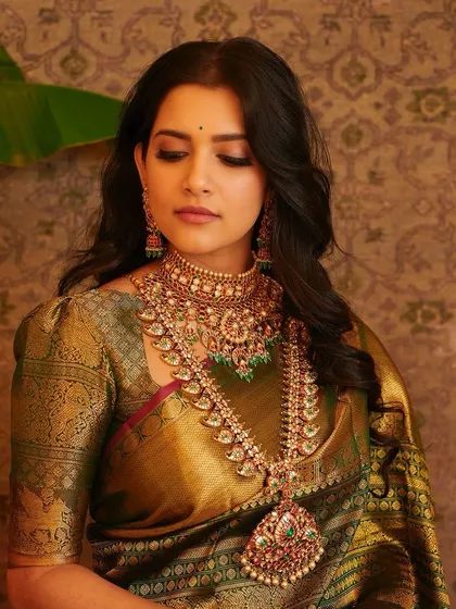 A serene, eyes-closed portrait, showcasing the soft, blended makeup and the beautiful details of her jewellery.