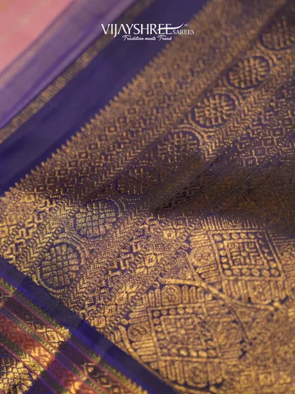 A close-up of the heavy, antique-finish gold zari on the blue border.