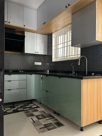 This shot captures the beautiful interplay of colors and textures in the kitchen, from the glossy acrylic cabinets to the matte finish of the geometric tiles.
