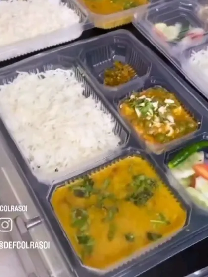 Our signature veg thali, neatly packed and ready to eat. It features a balanced combination of dal, paneer sabzi, rice, and salad, perfect for a nutritious lunch.