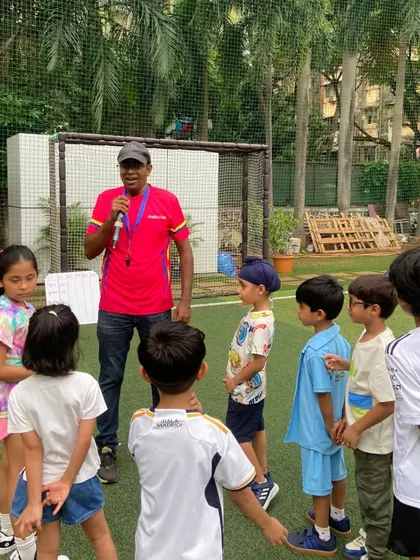 A head coach gathers the children to explain the next activity. We ensure our parties are well-structured, keeping the kids engaged and the