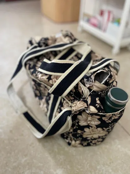 A top-down view of the diaper bag, highlighting the easy-access side pocket, perfect for a water bottle.