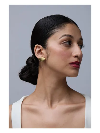 A clean and simple shot to showcase minimalist gold earrings. The focus is entirely on the product and how it looks when worn, perfect for a brand catalog.