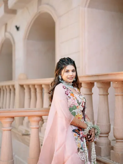A beautiful Haldi look with soft waves and a double braided crown, creating a bohemian and romantic vibe.