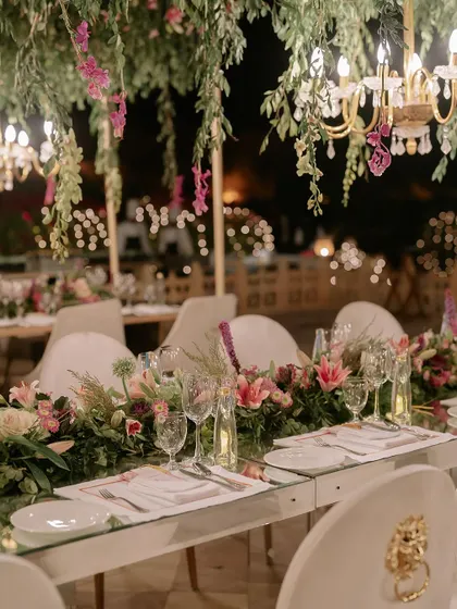 The art of celebration is in the details. This shot from a finale dinner shows our meticulous approach to tablescaping, where fresh floral arrangements, elegant glassware, and ambient lighting come together to create an unforgettable dining experience.