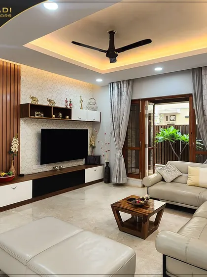 A full view of the living room, showcasing the decorated TV unit, comfortable sofa, and the seamless connection to the outdoor patio, perfect for modern family living.