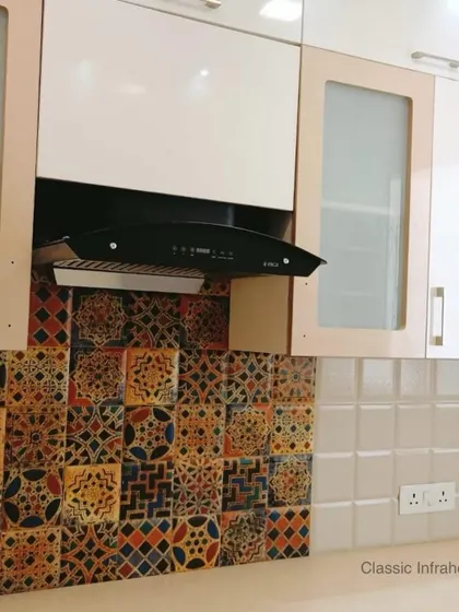 A detailed look at the vibrant Moroccan tile backsplash used in the Great Value Sarnam project. This adds a pop of color and personality, acting as a beautiful focal point above the cooking area. We use a variety of backsplash materials to match your style.