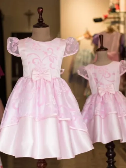 A beautiful set of matching pink party dresses displayed in my boutique. This shows how I can create identical looks for sisters of different ages.
