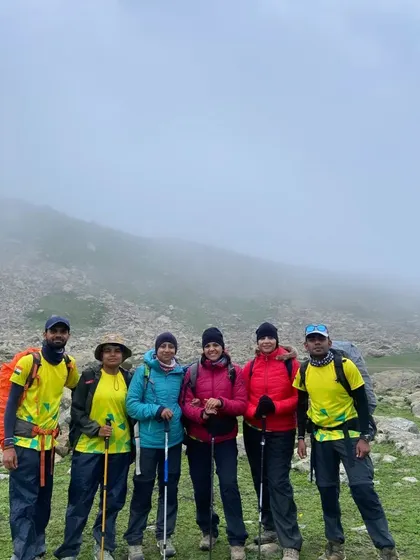 A team braving the misty, rugged terrain of the Kashmir Great Lakes trek. These high-altitude treks are the ultimate test of resilience and teamwork.