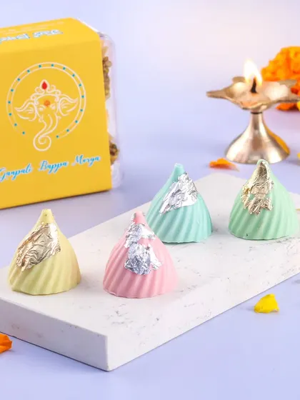 Our delicate chocolate modaks are filled with deliciousness and topped with silver leaf. They are a beautiful addition to any Ganpati celebration.