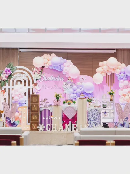 A wide shot of Chakrika's party, showing the stage setup in the venue.