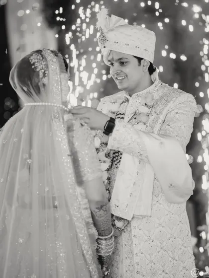 The sacred moment of the groom tying the mangalsutra, captured in classic black and white to emphasize its significance and timelessness.
