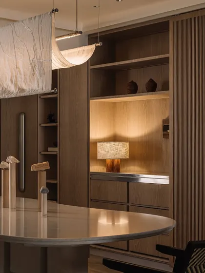 A moody shot of the dining room details on a rainy day, emphasizing the textures and the soft, ambient lighting.