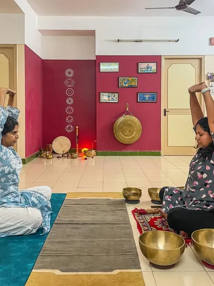 Students prepare for a practice session by doing gentle yoga stretches. I believe in a holistic approach, where preparing the body through movement and breathwork enhances its receptivity to sound meditation.
