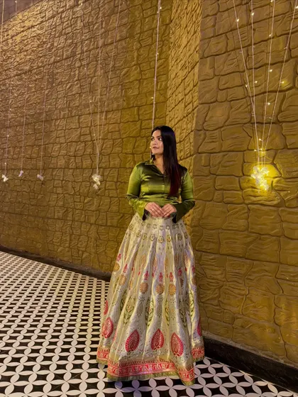 A full-length view of the satin shirt and Banarasi lehenga combination. This fusion look is perfect for a wedding reception or a festive evening party.