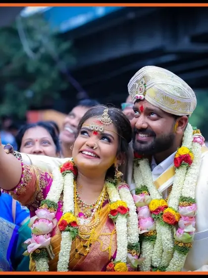 A beautiful candid shot of the couple and their family, capturing a moment of shared happiness and celebration during the wedding festivities.