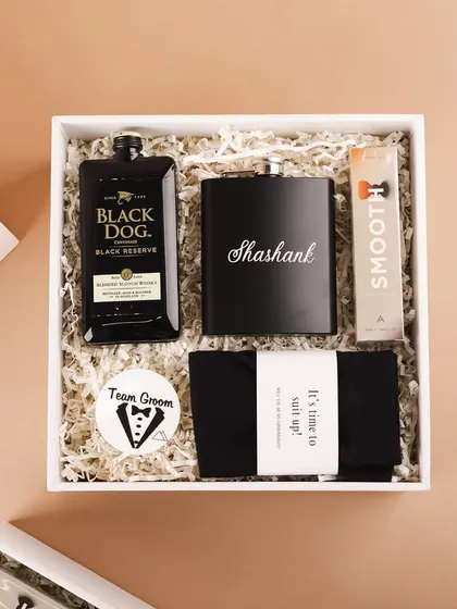 An overhead view of the groomsmen hamper, showing all the curated items neatly arranged. It's the perfect gift for the guys who planned the bachelor party.