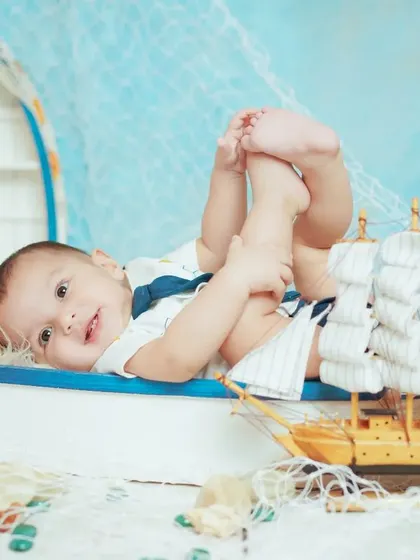 A playful pose from our sailor-themed shoot. We capture a variety of shots, from sitting and smiling to lying down and playing.
