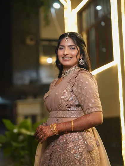 Vindya's reception look under the evening lights. The makeup has a soft shimmer to catch the light, perfect for a party atmosphere.