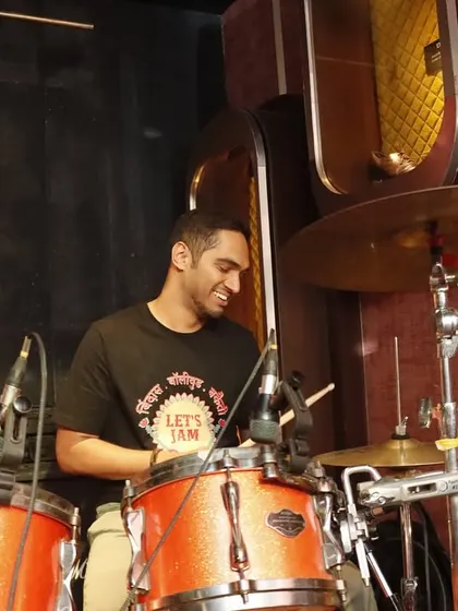 Our drummer, all smiles behind his kit. He is the heartbeat of our band, keeping the energy high all night long.