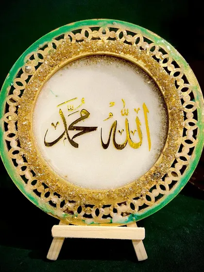Another view of the green and gold filigree plaque, showing its elegant design.