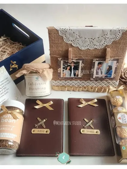 A wonderful gift for a newlywed couple, combining practical and personal items. This set includes matching personalized passport covers, a scented candle, Ferrero Rocher chocolates, and a decorative photo display basket.